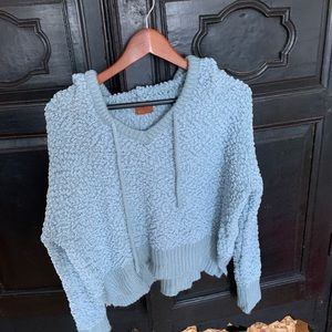 Blue cozy sweater with hood and strings